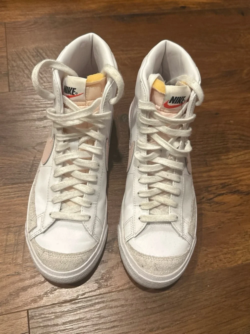 Nike Women's White High-Top Sneakers with Pink Swoosh Accent